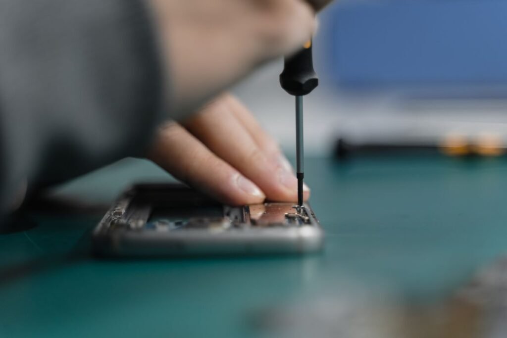 Hands working on a mechanical watch movement