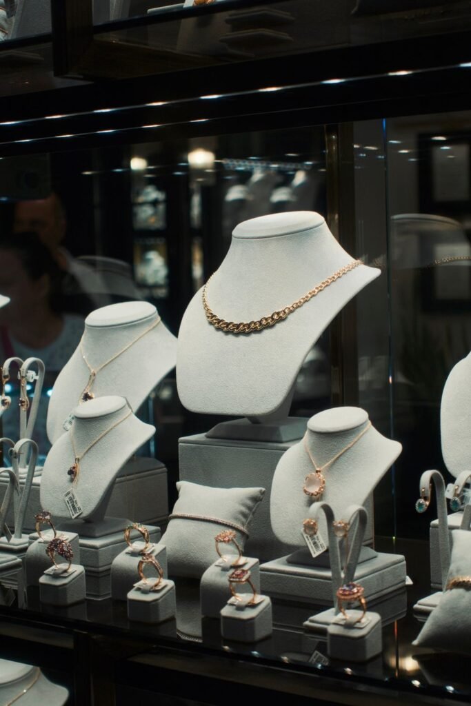 Necklaces on display busts in a jewelry case